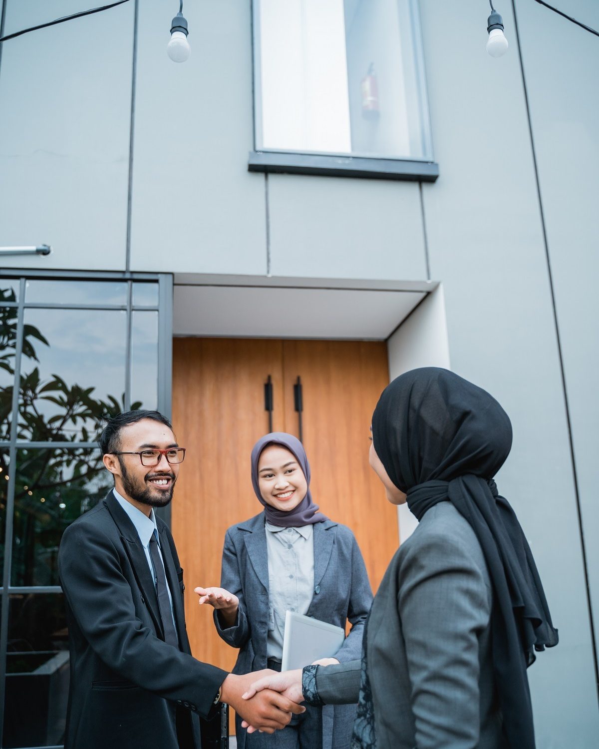 asian muslim businesswoman shaking hand with partner at the office during meeting